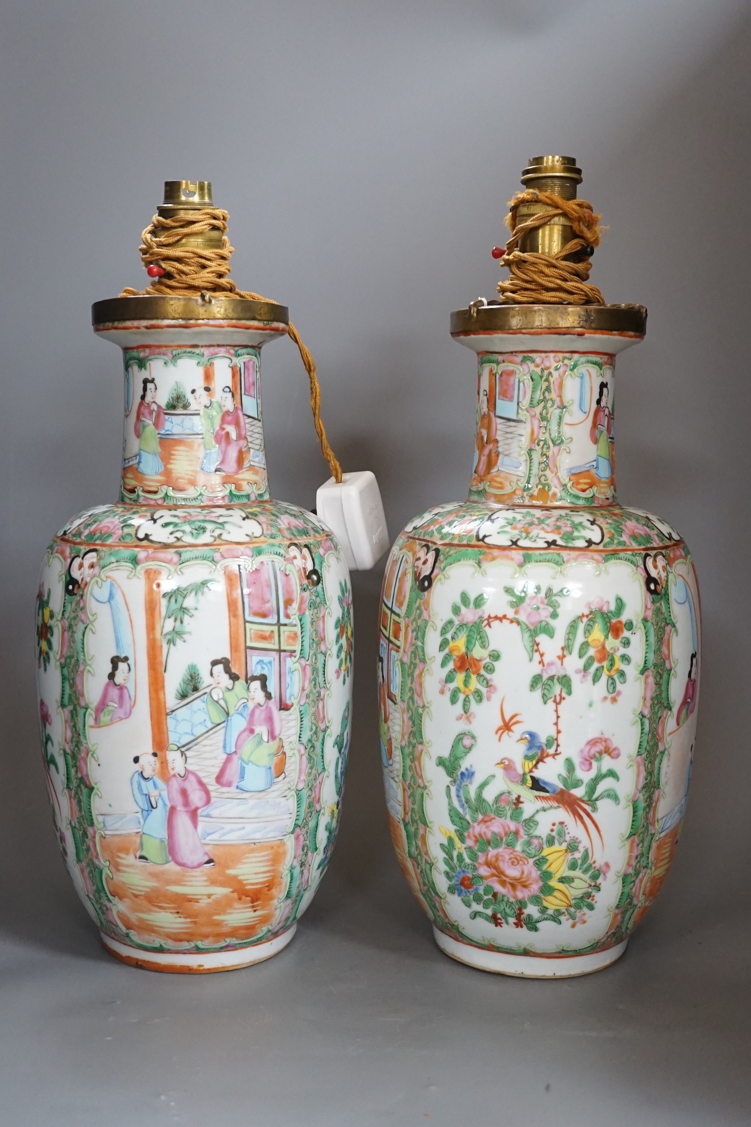A pair of Chinese Canton famille rose vases, late 19th century, mounted as lamps, total height 43cm